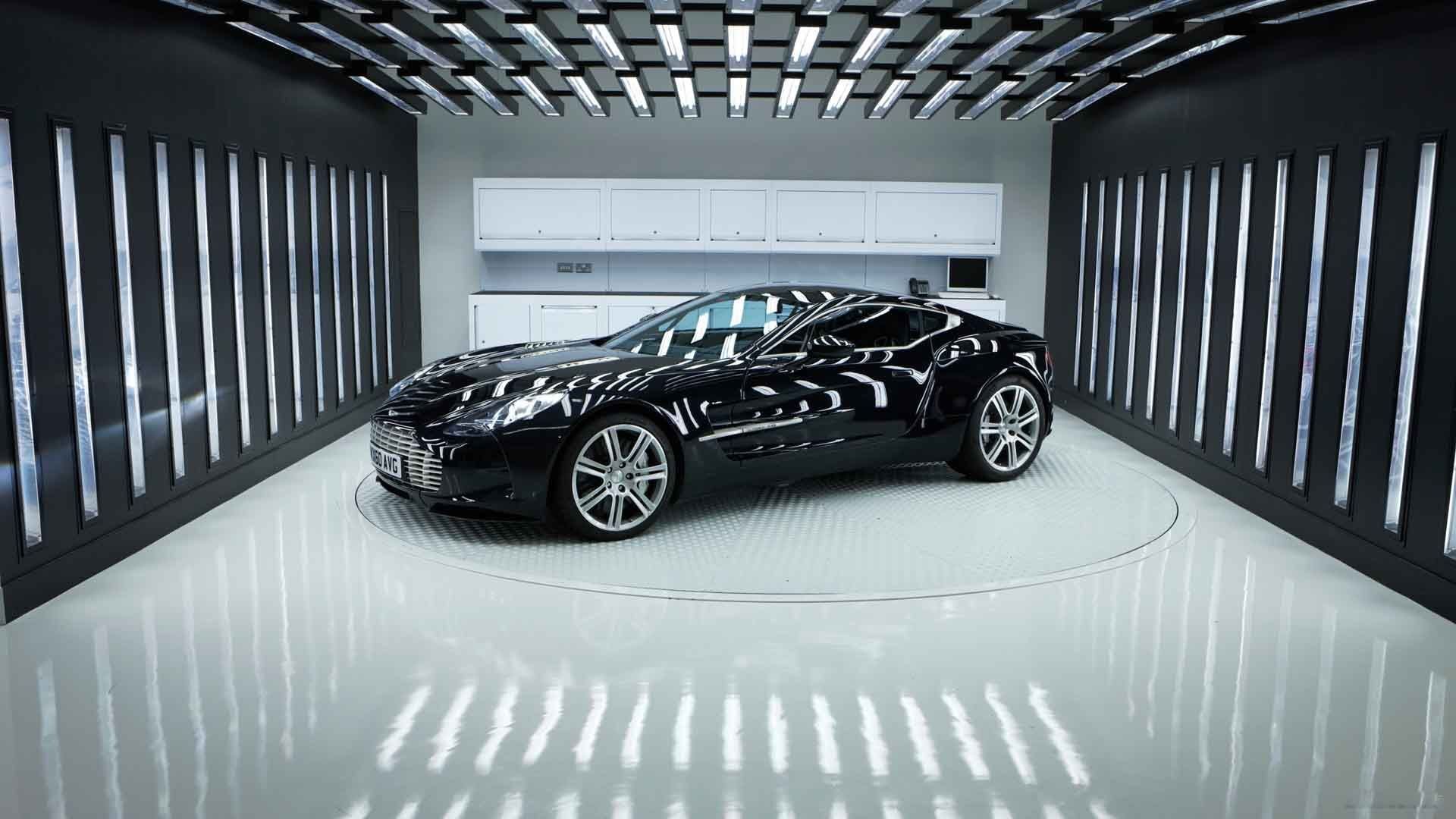 A polished black car in a bright studio